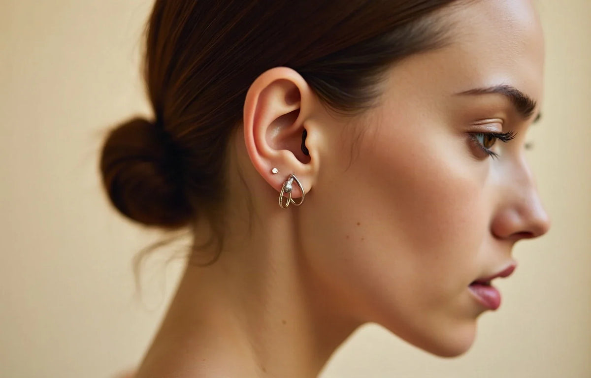 Serene ear wearing delicate titanium and gold piercings